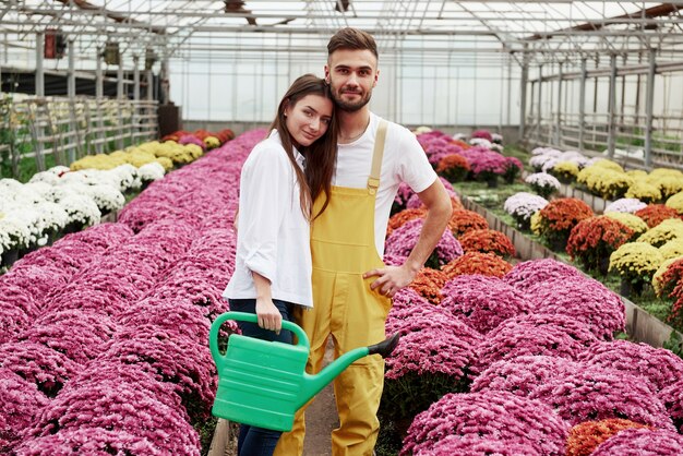 Nice couple. Beautiful pair standing in the garden leaning against each other and feels joy.