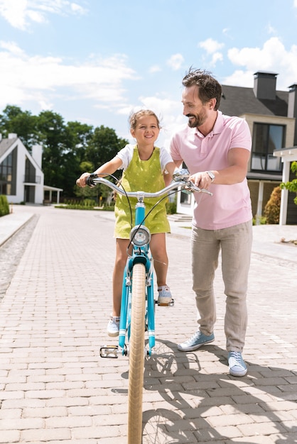 Nice cute girl smiling while enjoying the bicycle ride