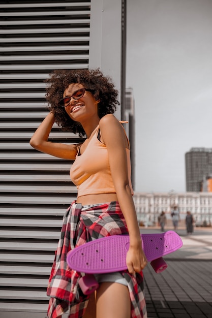 Nice and cute young woman in orange top looking good