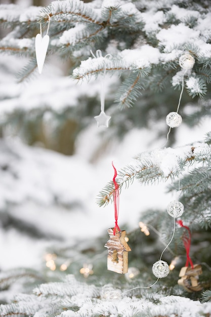 屋外で雪が降るクリスマスツリーの素敵な装飾