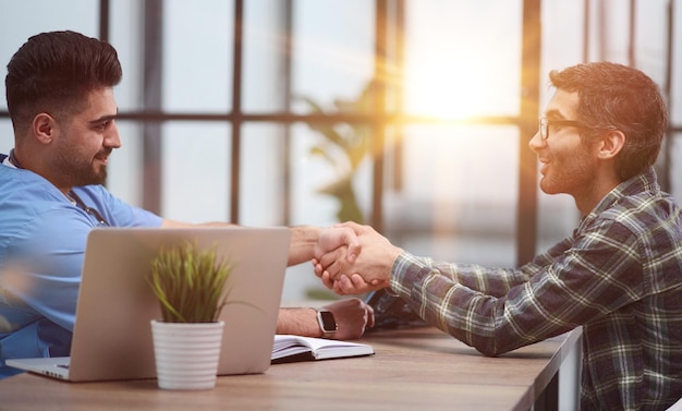 Nice doctor shaking hands with the patient