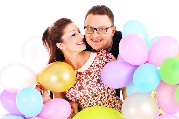 Nice elegant young couple with colorful ballons