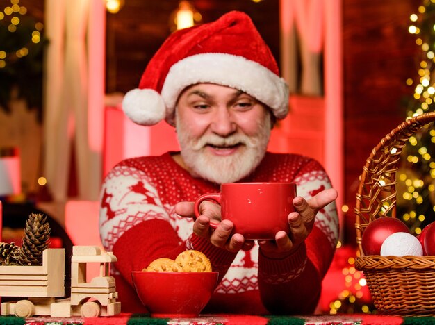Nice evening. xmas party celebration. bearded man eat cookies. winter holiday mood. grandpa drink milk. christmas composition. ready for new year party. santa have dinner. for santa.