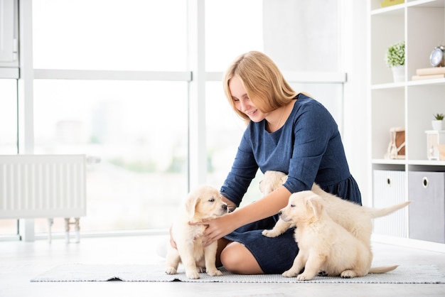 Nice girl playing with puppies