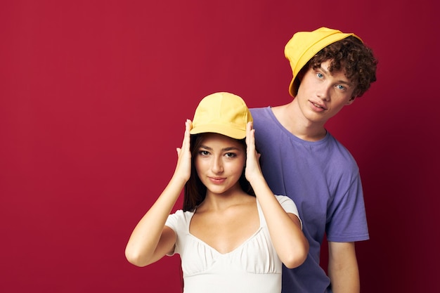 Nice guy and girl in colorful tshirts stylish clothes hats isolated background