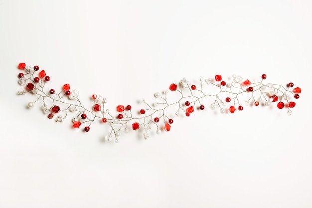 Nice hair accessory with white and red beads over a white background