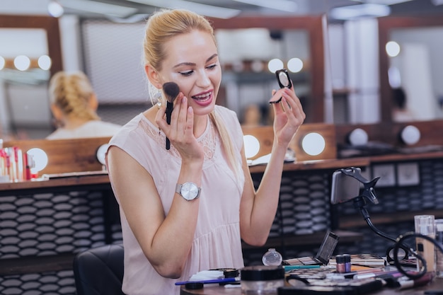 Foto bel taglio di capelli. giovane donna alla moda con una bella acconciatura godendo le riprese di video sui cosmetici