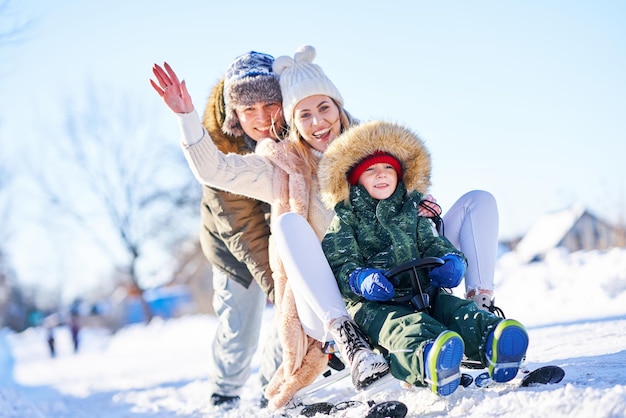 Nice happy family having fun on winter snow. High quality photo