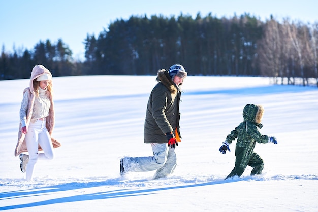 Nice happy family having fun on winter snow. High quality photo