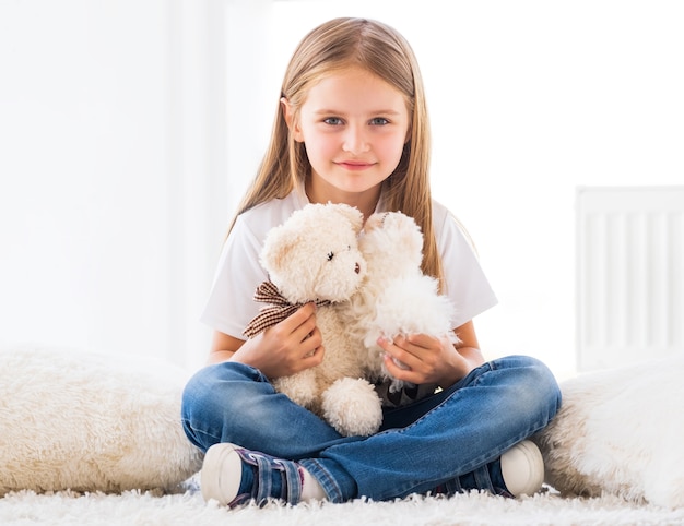 Nice little girl playing toys in light room