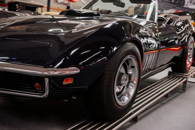 Nice looking old sport car standing on the special stand indoors at automobile show