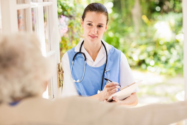 Nice nurse checking patients health at home