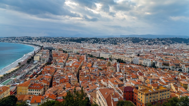 Nice old town French Riviera France View of the city with red roofs colorful houses and narrow streets Promenade des Angles and azure sea from above Travel Europe