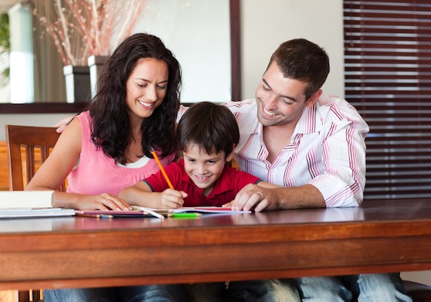 Nice parents helping their son for homework