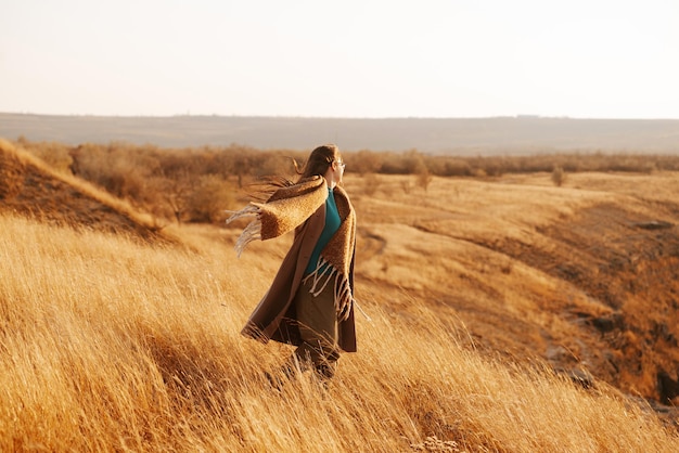 A nice picture of a woman enjoying the nature on a hill