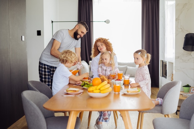 Nice pleasant family waiting for the juice