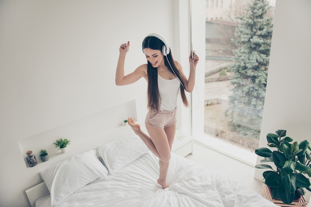 Nice positive girl posing in her bed