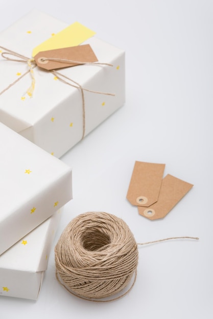 Nice present packed in white paper with small yellow stars on white background