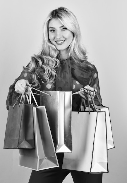 Nice purchase sexy blonde carry shopping bags elegant woman shopaholic girl shopper hold paperbag package buy presents online gift shop for any holiday sellout on black friday Clothing store