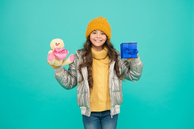 Nice purchase. small girl happy about xmas present. gift with love. merry christmas. happy new year. gift for winter holidays. stylish kid in warm winter clothes. shopping online with extra bonus.