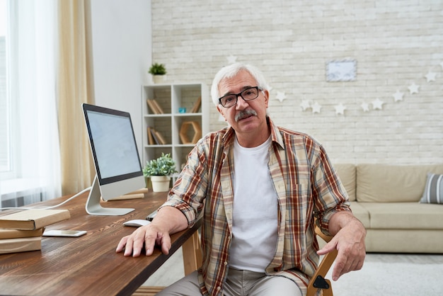 Nice Senior Man Sitting by Computer