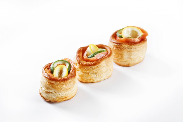 Nice set of rolled pancake canapes with lemon, lime and salmon