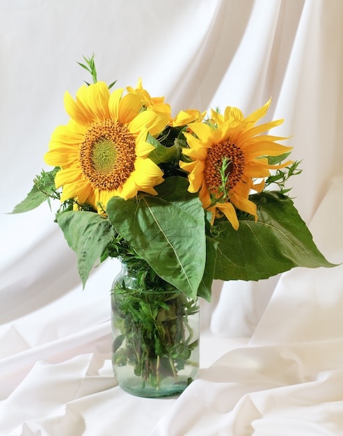 Nice sunflower summer bouquet on white cloth background