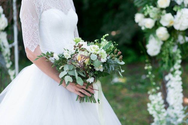 nice wedding bouquet in bride and groom hand