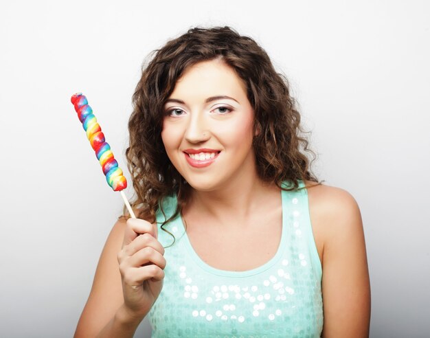 Nice young curly girl with lolipop