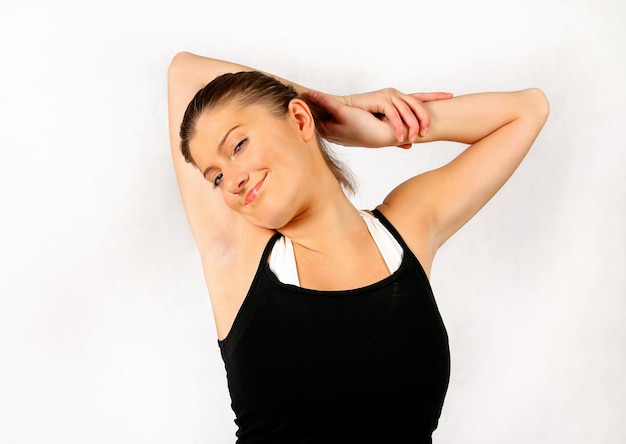 nice young and happy woman stretching over white background