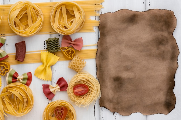 Nicely spread pasta and spaghetti with aged parchment sheet