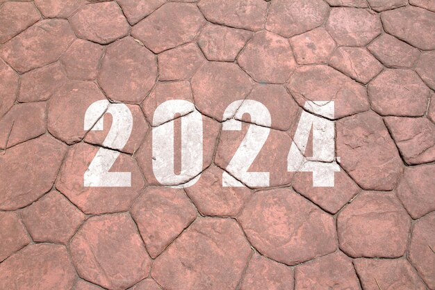 Foto nieuw jaar 2024 de tekst van 2024 is op de grond geschreven.