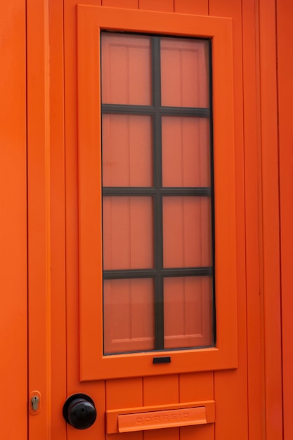 Nieuwe gesloten moderne helderoranje deur close-up achtergrond