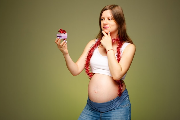 Nieuwjaarsviering met cadeaus voor een zwangere vrouw Zwangere vrouw met het heden