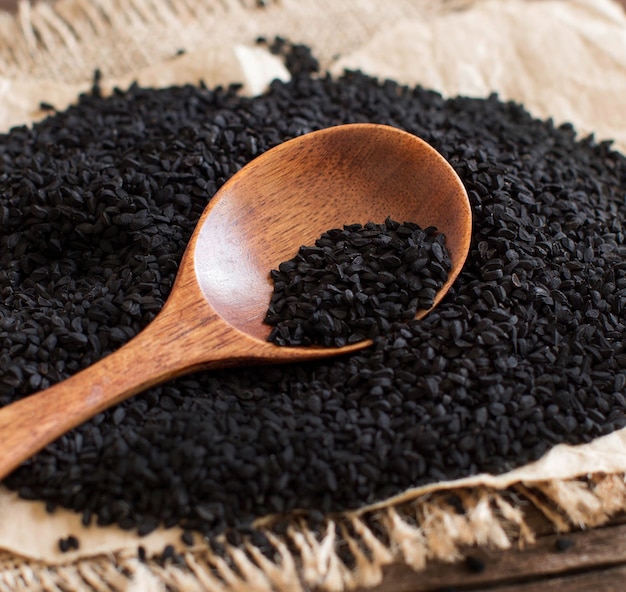 Nigella sativa or Black cumin with a spoon close up