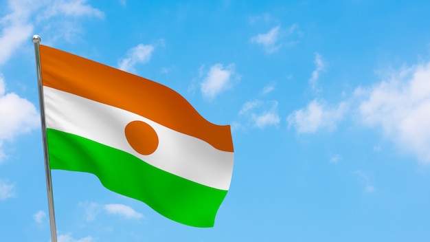 Niger flag on pole. Blue sky. National flag of Niger