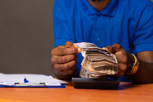 A nigerian man counting some money