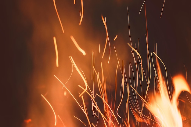 Night bonfire background with smoke and sparks in motion blur