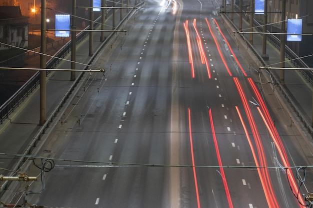 Night city The light trails on the street Slow shutter speed photo A long bridge across the river leads to the big city A busy expressway in the town center