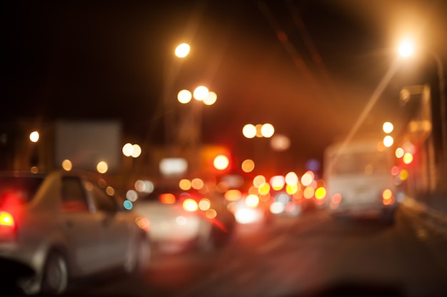 Night city street lighting lanterns and cars