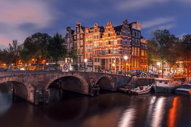 Night city view of Amsterdam canal and bridge