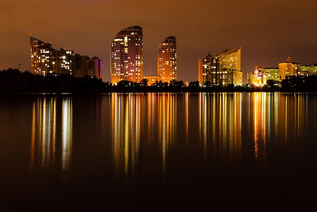 Night city with reflection of houses in the river