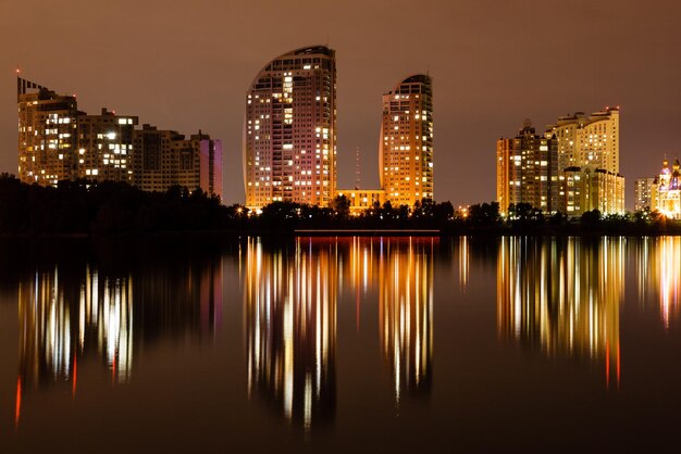 Night city with reflection of houses in the river