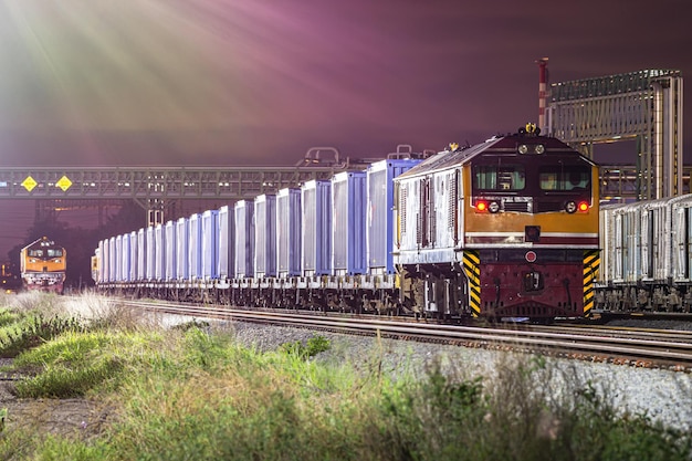 Night freight train in container yard