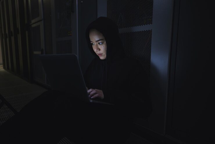 Photo night hacker and programming with woman and laptop for coding software and cyber security ransomware phishing and developer with girl programmer in server for database network and digital crimes