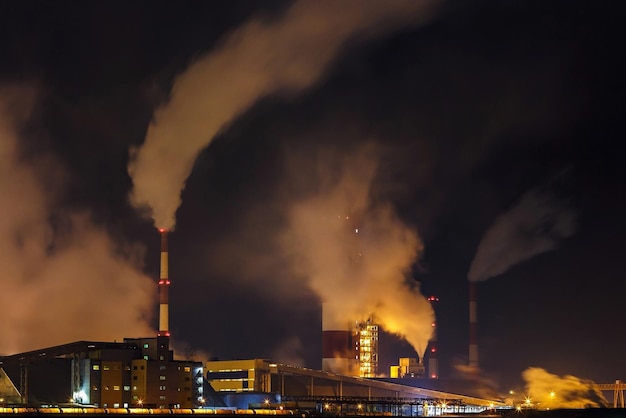 Night industrial landscape environmental pollution waste of thermal power plant Big pipes of chemical industry enterprise plant