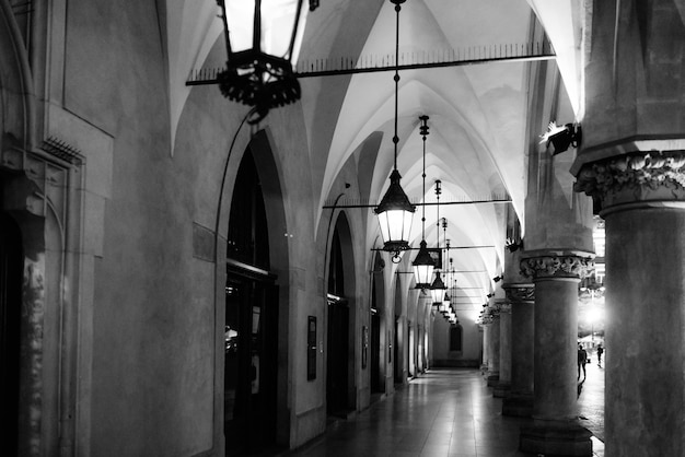 Night old commercial area of Krakow in the lights of street lamps. Old Europe.