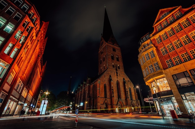Night photography of Hamburg on the crossroad View of St Petri church and traditional red brick