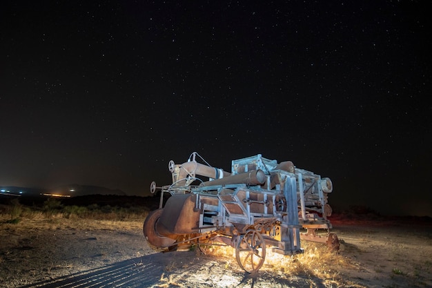 Night photography of an old cereal grain harvester in Granada.