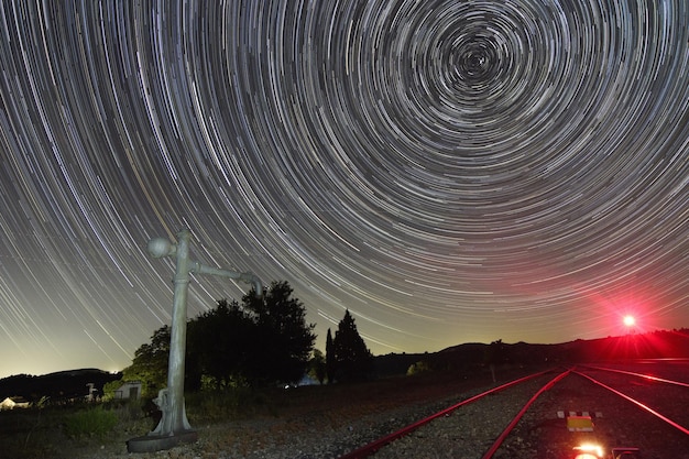 Photo night photography over the water fountain of the alamedilla railway station